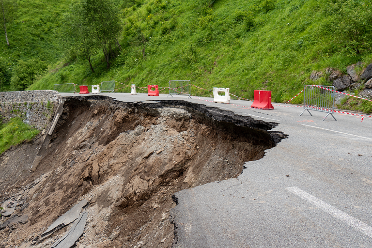 image showing collapsed slope and damage to roadway above